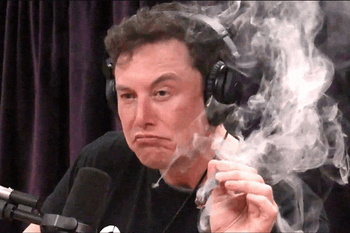 a man wearing headphones is smoking a cigarette and making a face