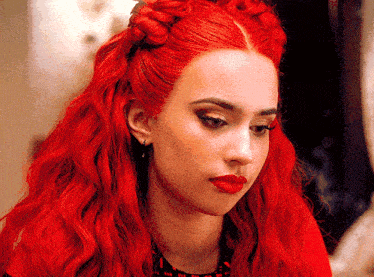 a woman with red hair has a braid in her hair
