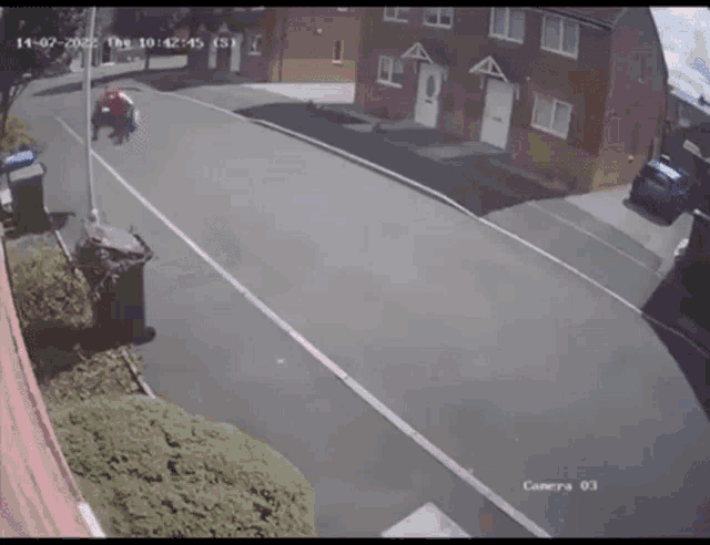 a person is riding a bike down a street with a camera on the side of the road .