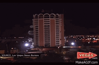 a large building is being demolished by a vegas arrow
