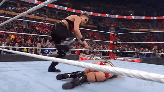 a woman in a wrestling ring with #womenstag written on the bottom