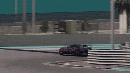 a black and red sports car driving on a track