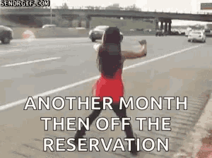 a woman in a red dress is dancing on a highway .