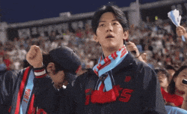 a man wearing a scarf that says ' s ' on it