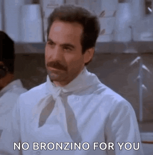 a man with a mustache is wearing a white shirt and tie and saying no bronzino for you .