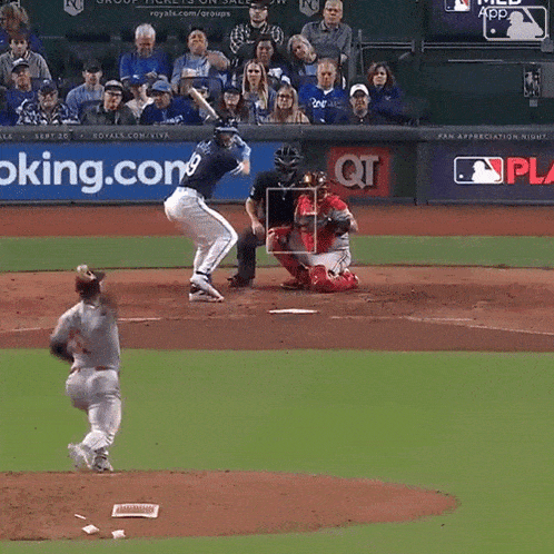 a baseball game is being played in front of a qt ad
