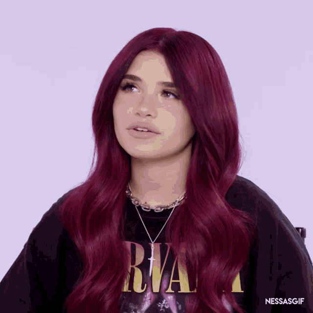 a woman with red hair is wearing a shirt that says nirvana