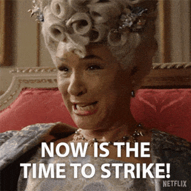 a woman sitting on a couch with the words now is the time to strike on her face