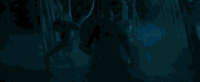 a ghost is standing in the woods with a blue light behind it .