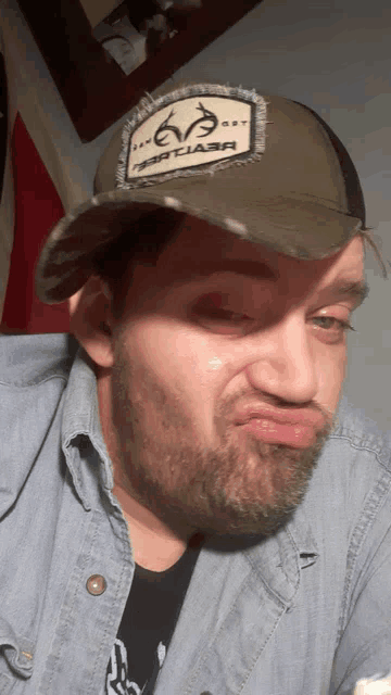 a man with a beard wearing a hat that says " deer class " on it