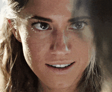 a close up of a woman 's face with half of her face visible