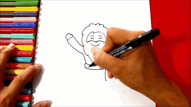 a person is drawing a picture of santa claus with a marker