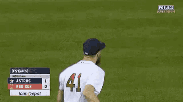 a baseball player wearing a red sox jersey is celebrating a win .