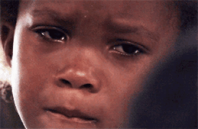 a close up of a child 's face with a serious look on her face