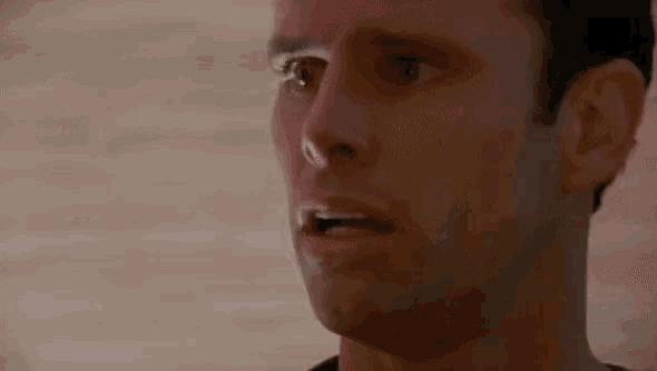 a close up of a man 's face with a surprised expression