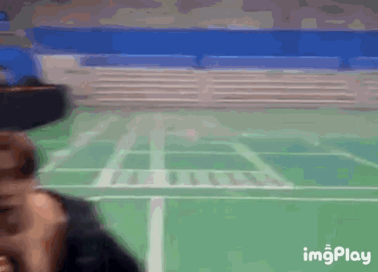 a blurry picture of a tennis court with the words imgplay on the bottom right