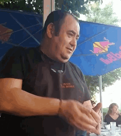 a man wearing an apron and a black shirt that says ' la rousse ' on the front