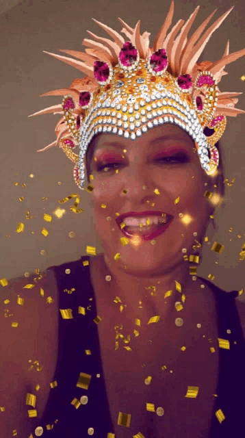 a woman wearing a crown with confetti falling around her face