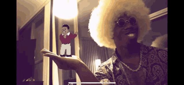 a man with an afro and sunglasses is holding a pixelated figure of a man
