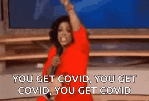 a woman in a red dress is holding a microphone and saying you get covid you get covid