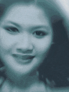 a blurry picture of a woman 's face with a slight smile
