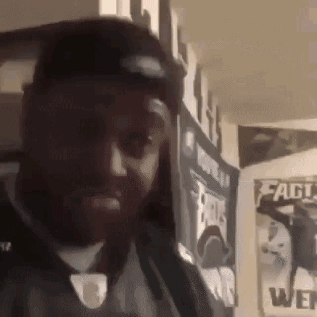 a man wearing a green jersey is standing in front of a wall with a banner that says eagles on it .