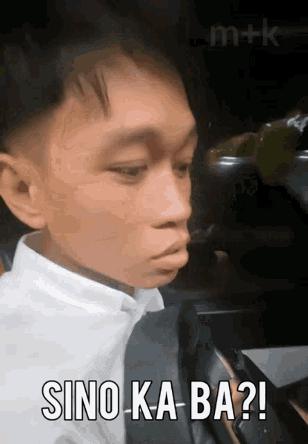 a man in a white shirt and black tie says sino-ka-ba ?