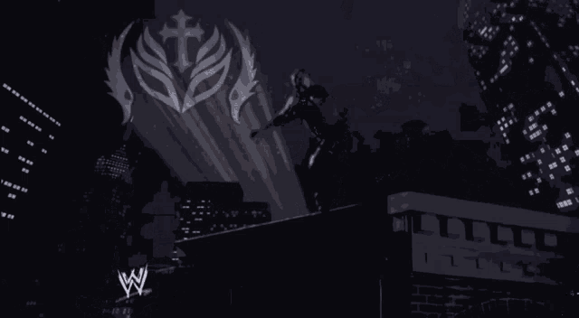 a man is standing on a ledge with a w logo behind him