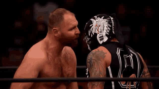 a wrestler wearing a mask with the number 10 on the back