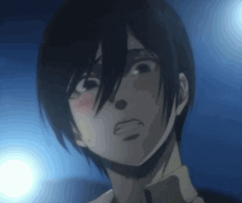 a close up of a person 's face in a dark room