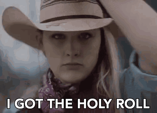 a woman wearing a cowboy hat and a bandana is saying `` i got the holy roll ''