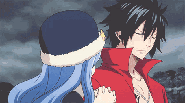 a man in a red jacket stands next to a woman with blue hair