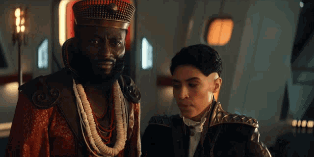 a man with a beard is standing next to a woman