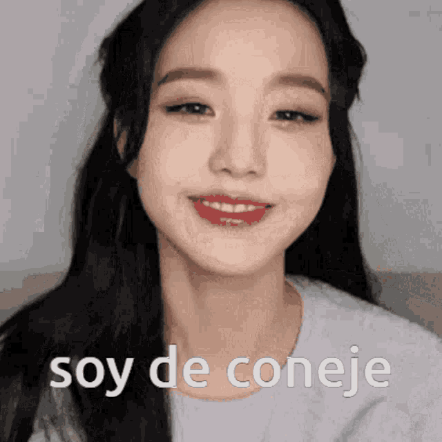 a close up of a woman 's face with the words soy de conejo in white letters