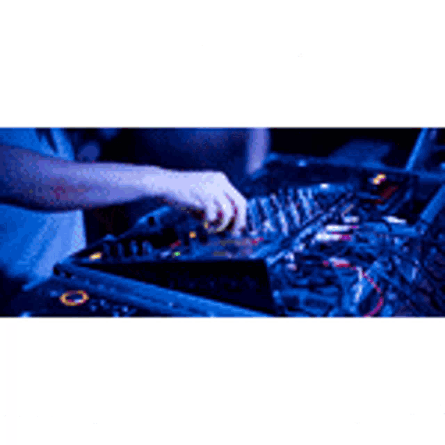 a person is playing a record on a turntable in a dark room .