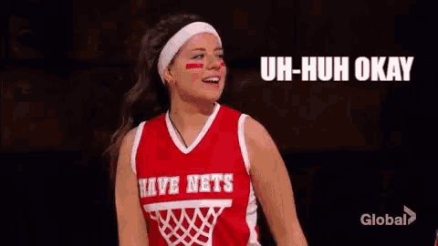 a woman in a basketball uniform is standing next to a man in a basketball uniform and says uh-huh okay .