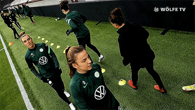 a group of women are standing on a soccer field with a wolfe tv logo in the corner