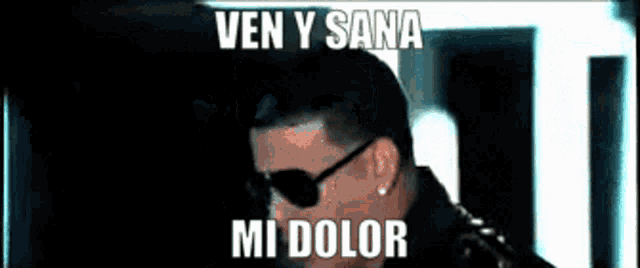 a man wearing sunglasses with the words ven y sana mi dolor on the bottom