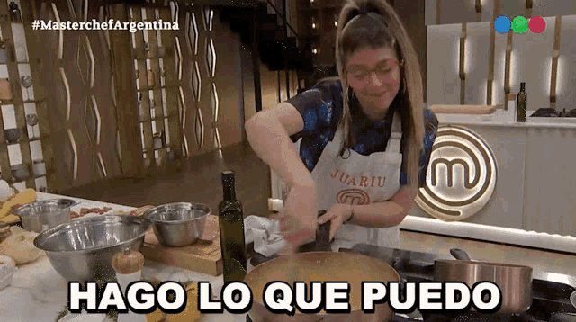 a woman in an apron with the letter m on it prepares food