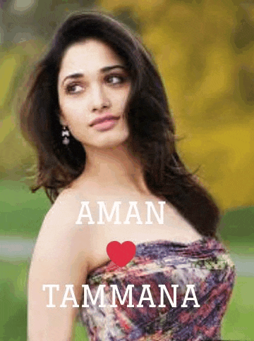 a woman in a strapless dress is standing in a field with a red heart in the background .
