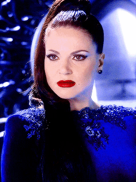 a woman wearing a blue dress and red lipstick