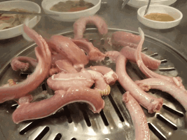 a bunch of meat is being cooked on a pan