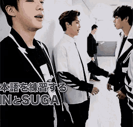 a group of young men are standing next to each other with the word suga on the bottom right