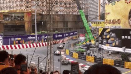 a crowd of people watching a race in front of a casino