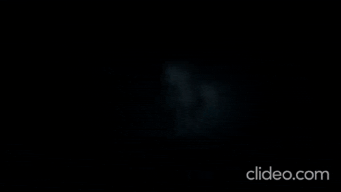 a person is flying through the air with a blue light behind them .