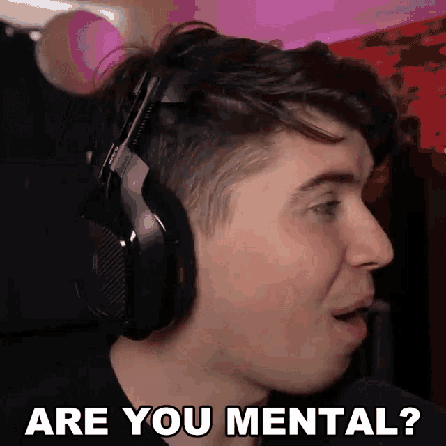 a man wearing headphones is making a funny face and says " are you mental "