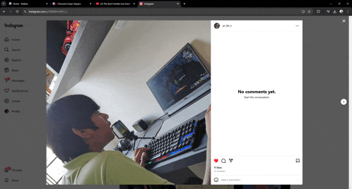 a man sitting at a desk playing a video game on a laptop with an instagram post displayed