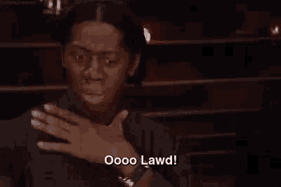 a woman is covering her mouth with her hand and saying oooo lawd !