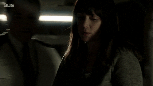 a woman is talking on a phone in the dark