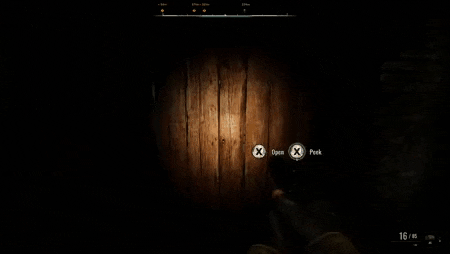 a person is holding a gun in a dark room with a light on .
